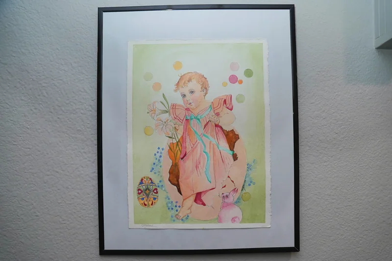 A framed print on the wall of the home