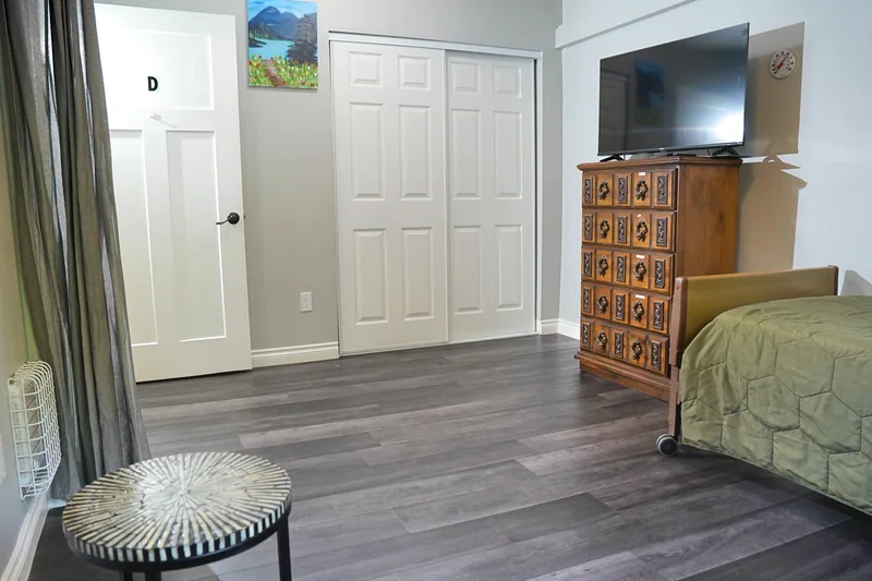 A resident bedroom with a wardrobe and television
