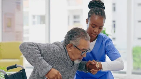 Stock image: a caregiver assisting an older adult