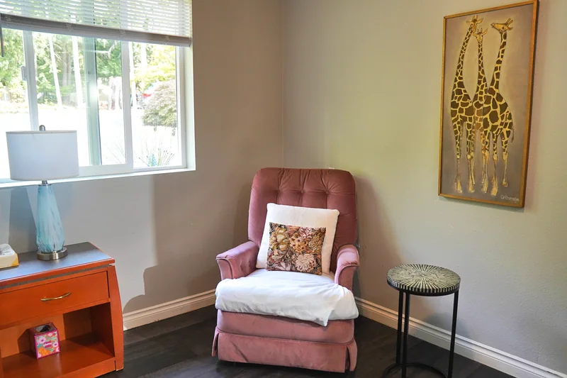 An armchair in a quiet corner beside the window