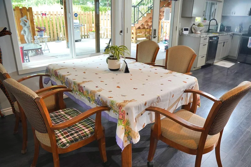 The dining table with chairs arranged around it