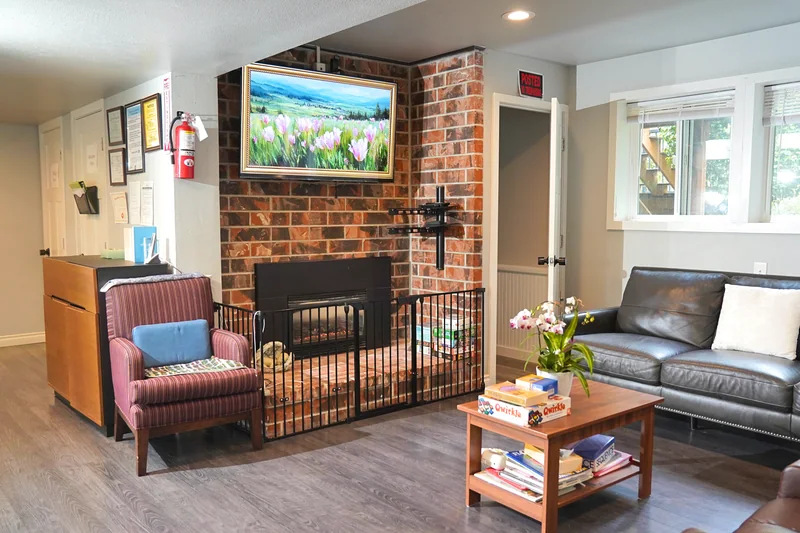 The living room at Bear Care AFH II with its brick fireplace