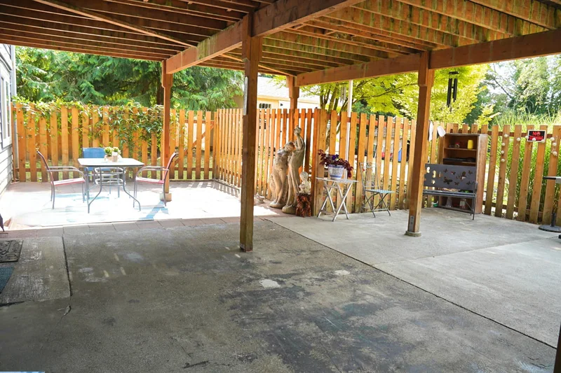 The covered patio at the side of the home