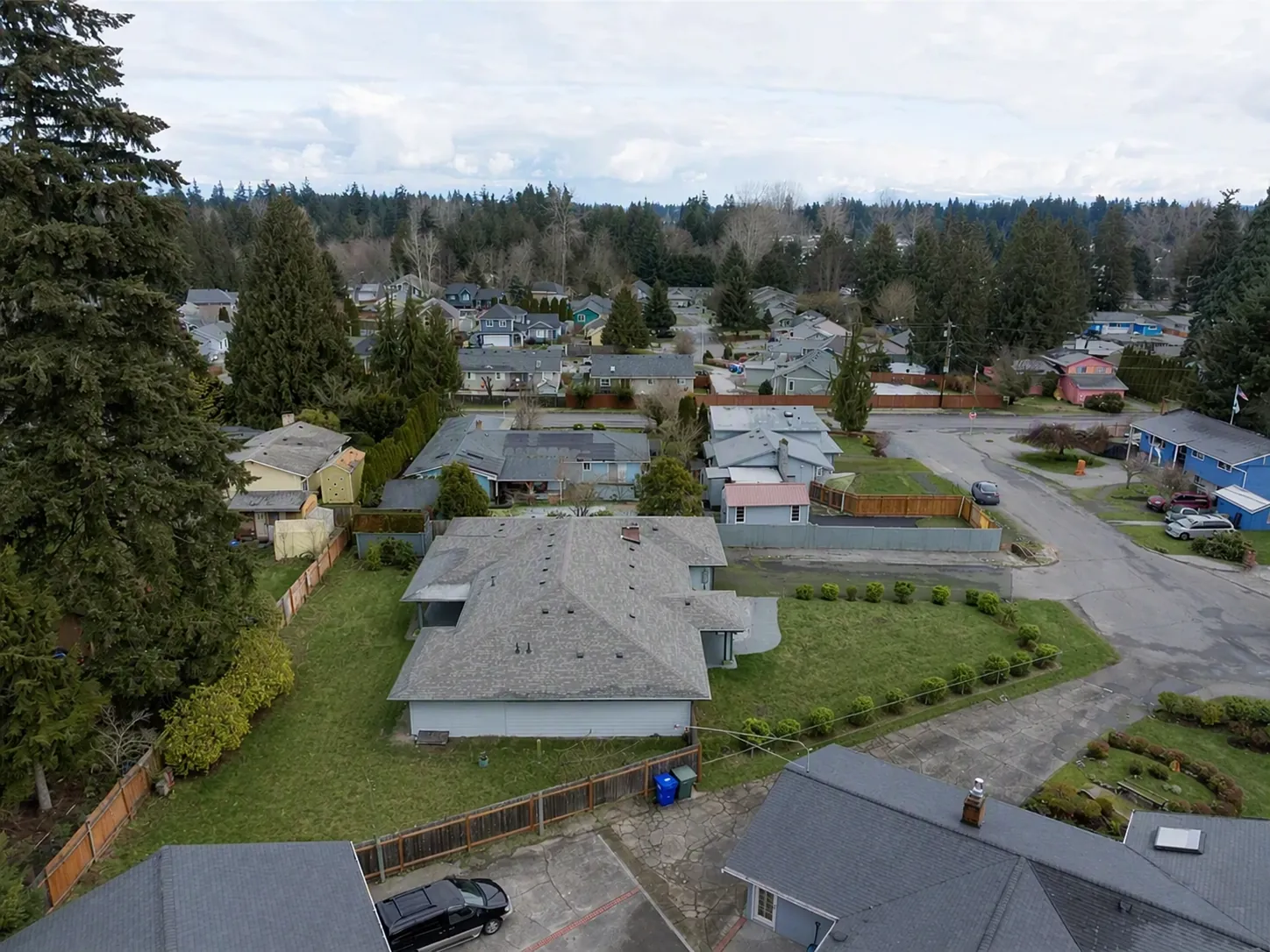 Aerial view of the home and its garden within the neighborhood