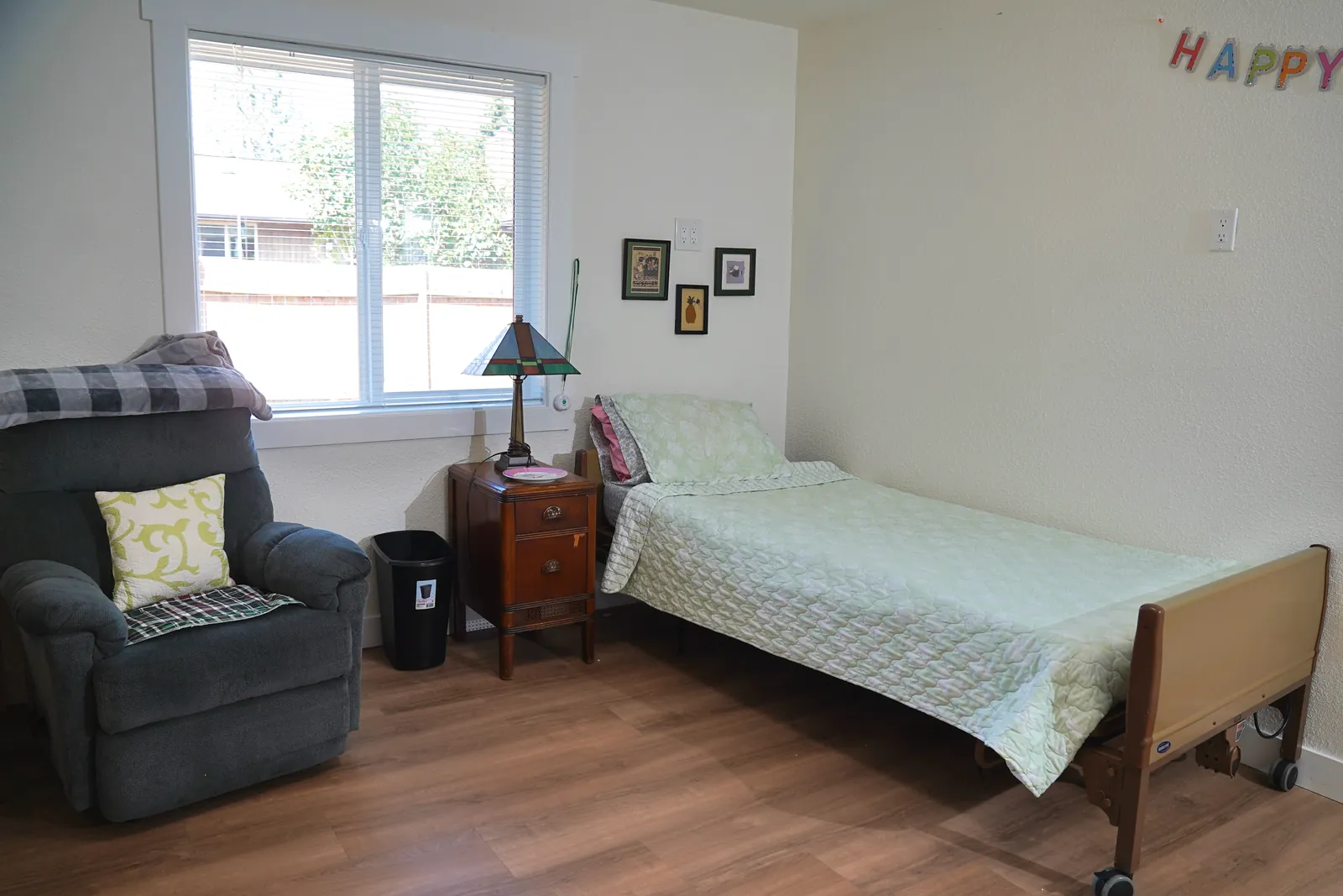 Bedroom with daylight from a window and a comfortable armchair