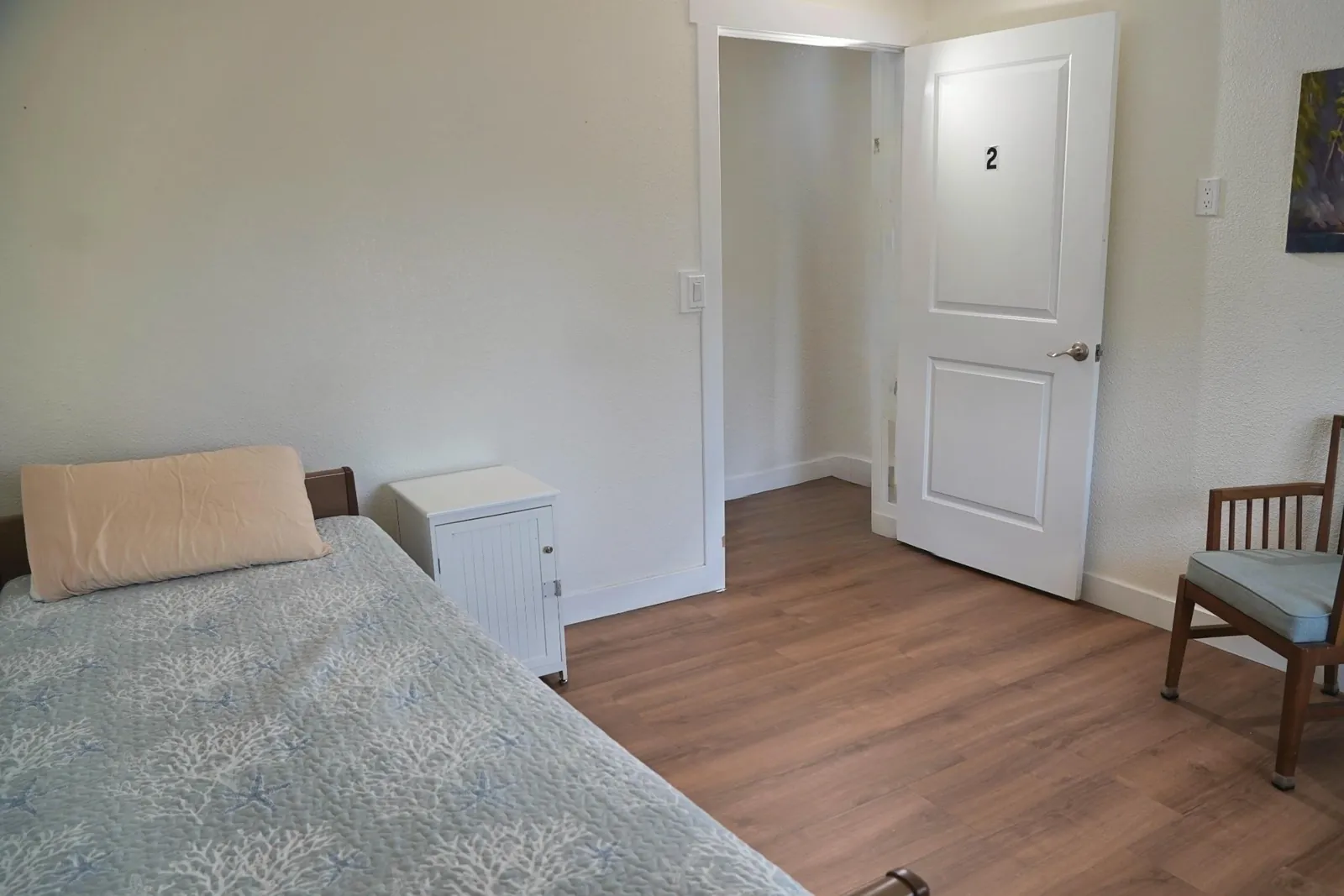 Bedroom with a numbered door opening onto the hallway
