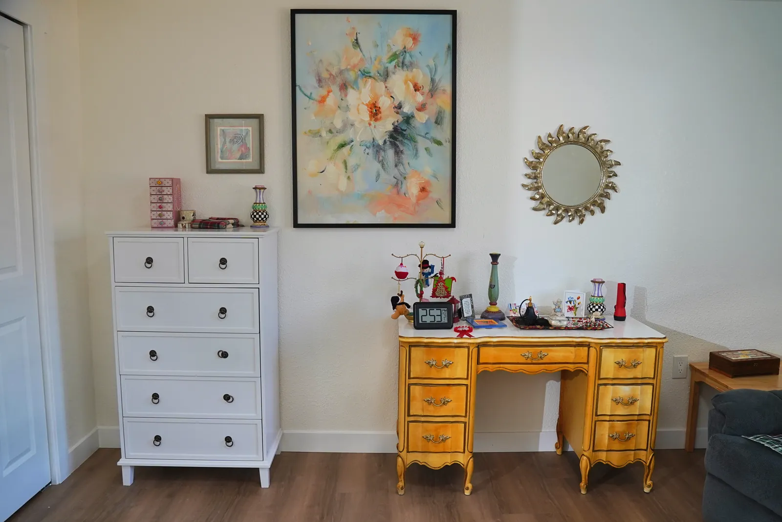 Bedroom with a chest of drawers, writing desk and framed picture