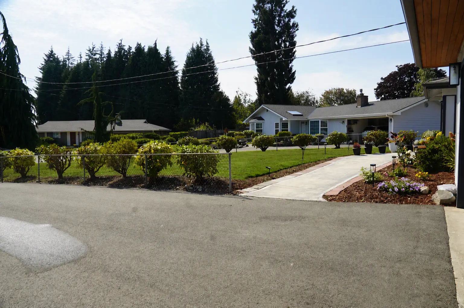 Wide driveway and front garden beside the house
