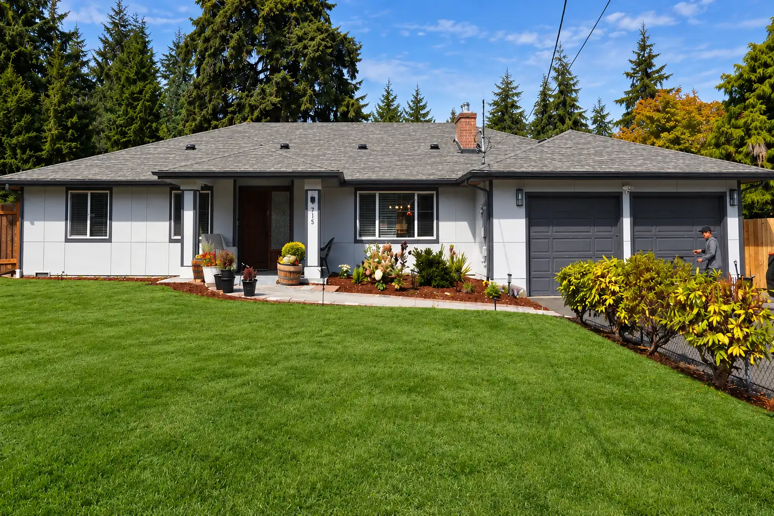 The front of the home, a single-storey house behind a wide front lawn