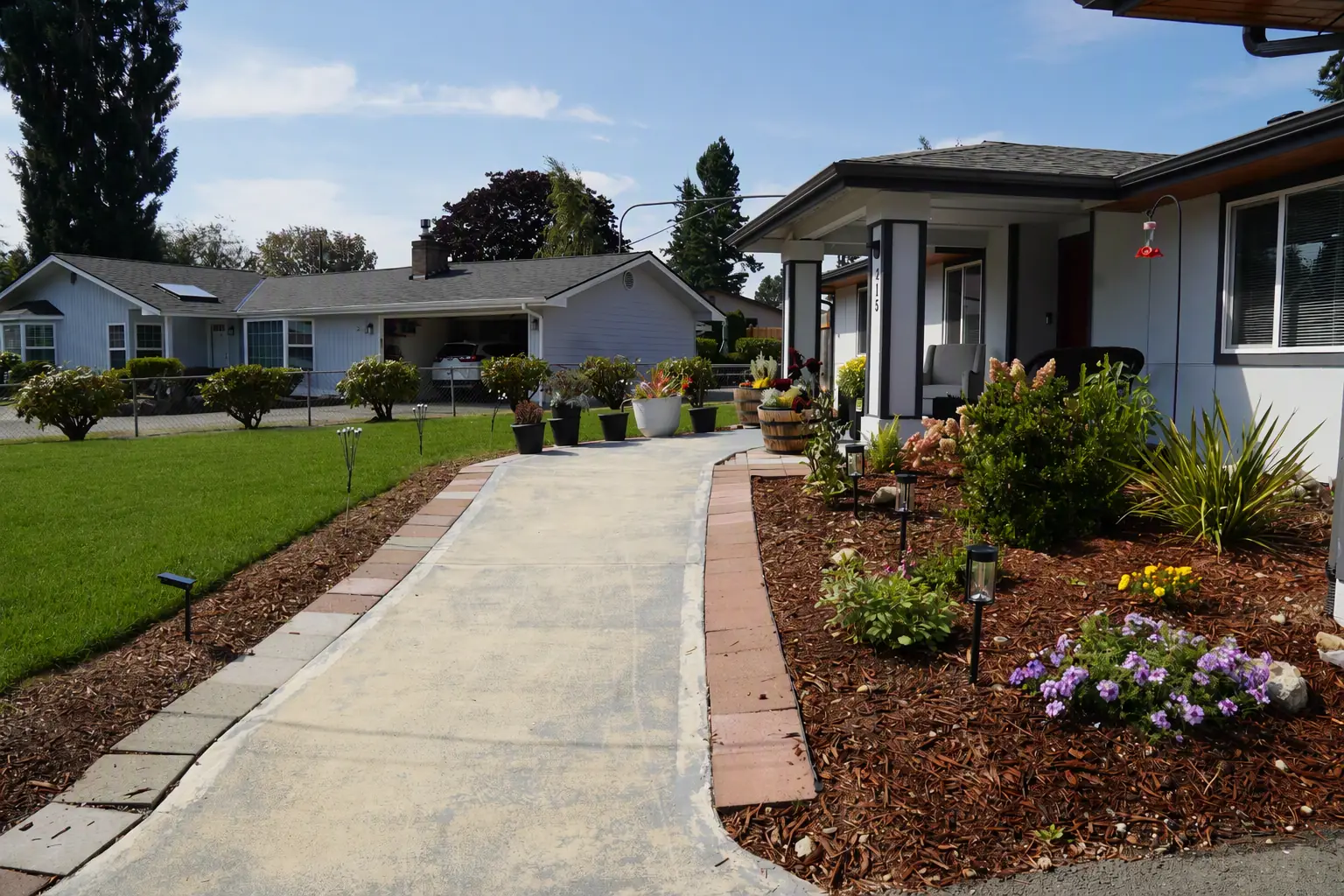 Front path leading to the entrance, edged with flower beds