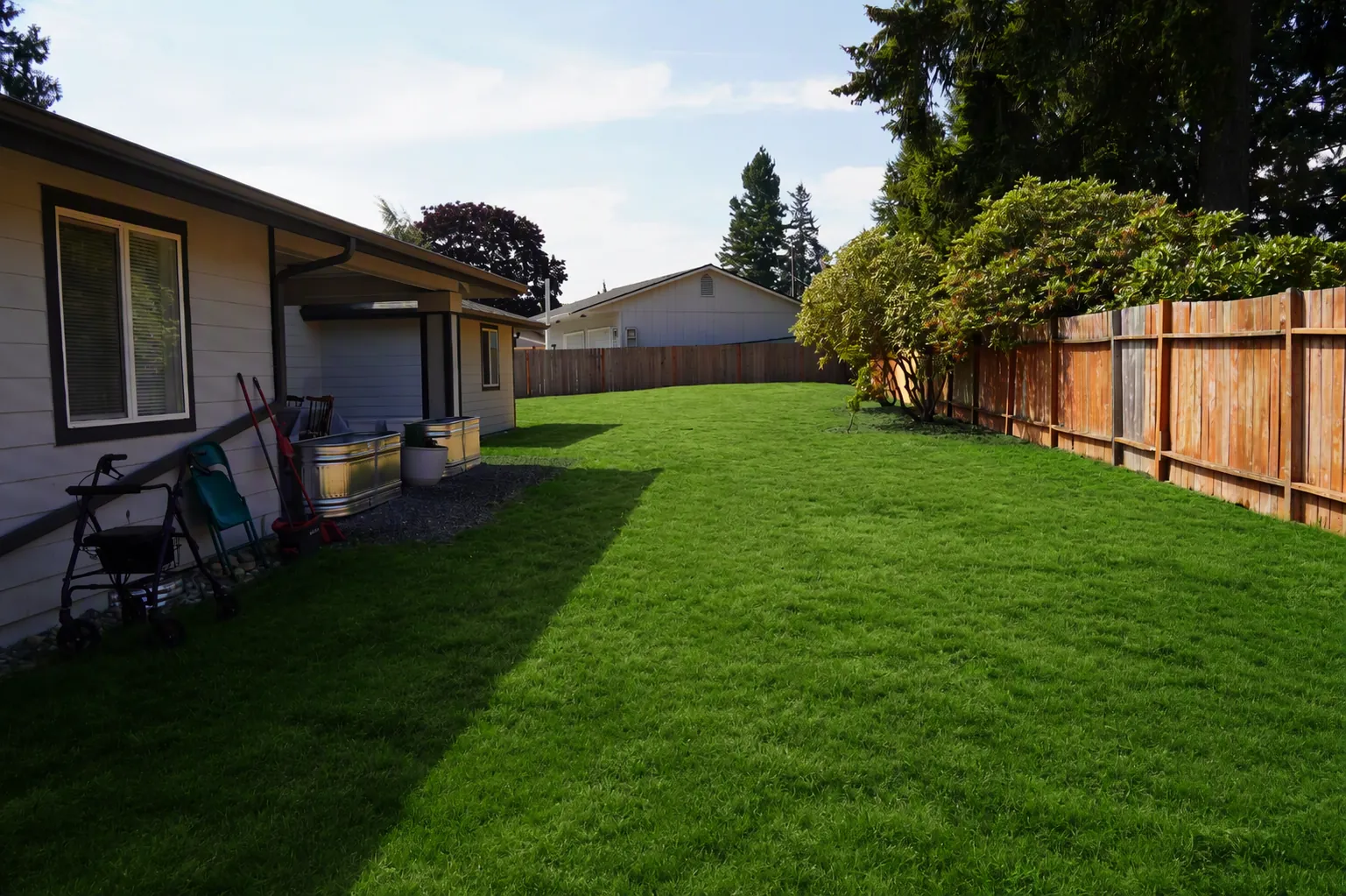 Side yard with lawn running to a timber fence