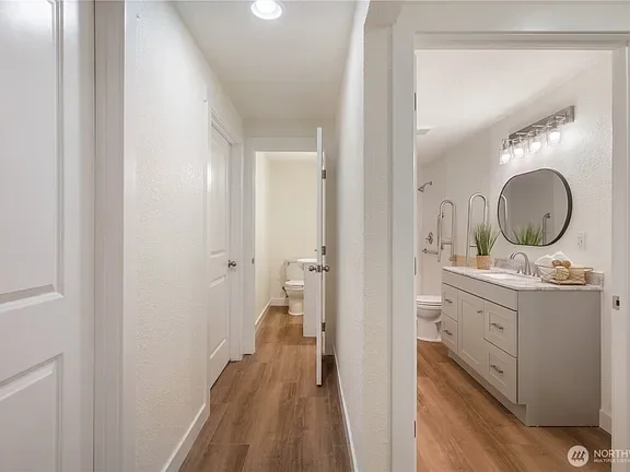 Hallway looking through an open door into a bathroom