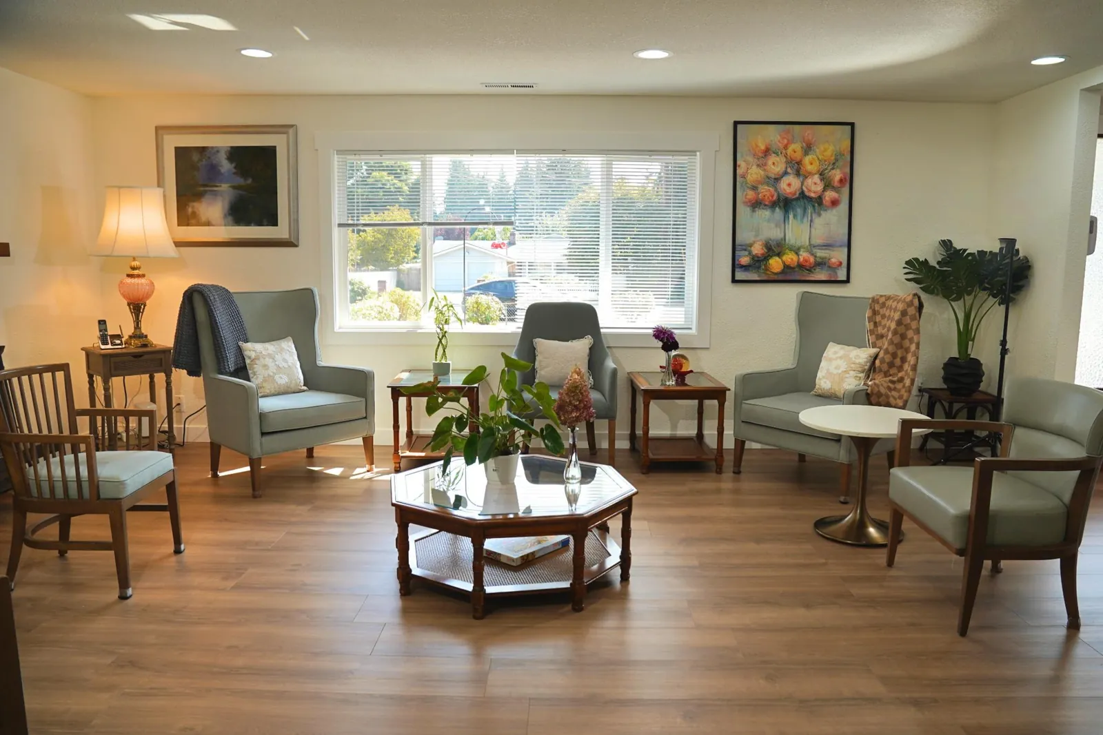 Bright living room with armchairs arranged around a window