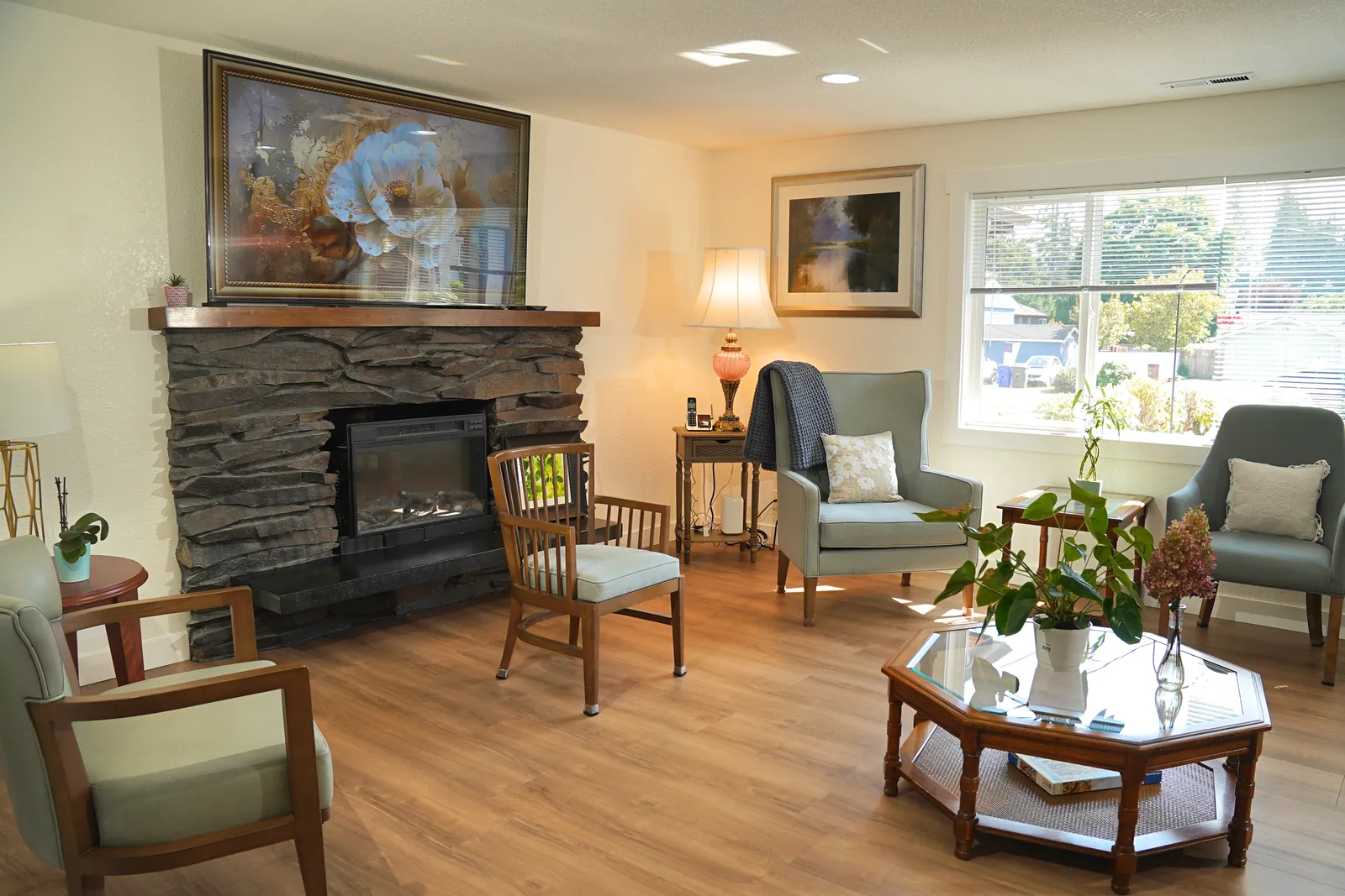 Armchairs beside the stone fireplace in the shared living room